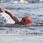 Triathlon swimmer with orange cap